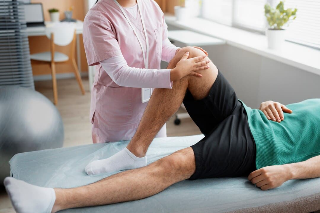 Experienced physiotherapist providing targeted neuro-rehabilitation exercises to a paralysis patient at home in Katraj.